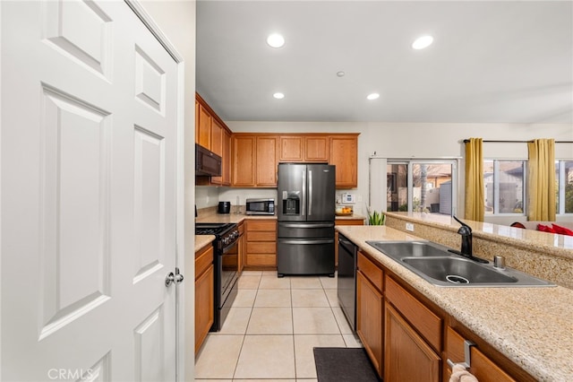 kitchen featuring light tile patterned flooring, sink, and black appliances