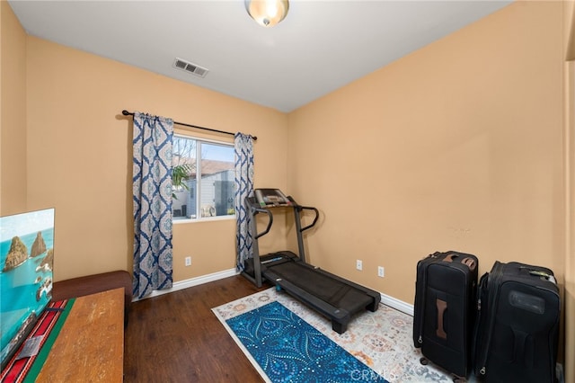 workout area with dark hardwood / wood-style floors