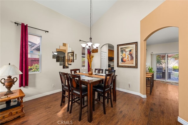 dining space featuring dark hardwood / wood-style flooring, a notable chandelier, and high vaulted ceiling