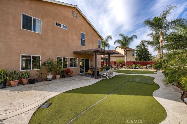 rear view of house featuring a yard, a pergola, and a patio