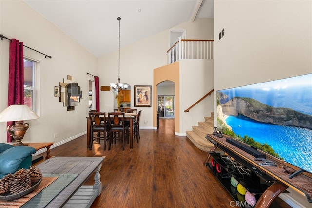 interior space featuring dark hardwood / wood-style flooring, high vaulted ceiling, and an inviting chandelier