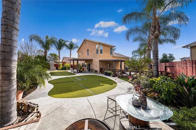 rear view of house with a patio area and a lawn