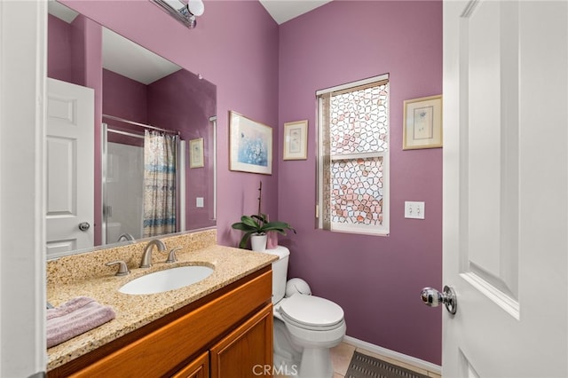 bathroom with vanity, curtained shower, tile patterned floors, and toilet