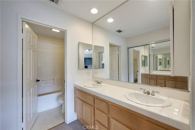 full bathroom with vanity, toilet, and bathing tub / shower combination