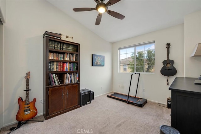 workout room featuring light carpet, vaulted ceiling, and ceiling fan