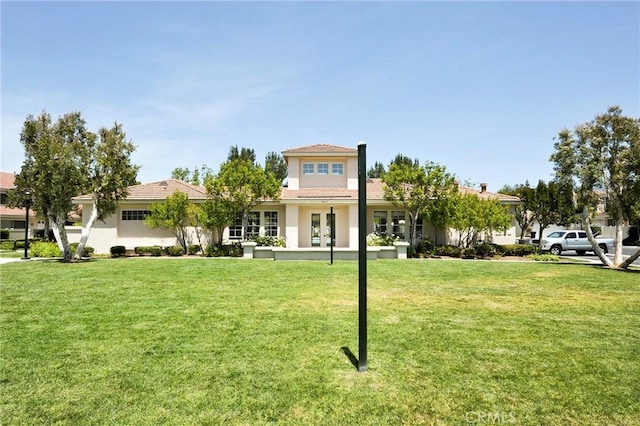 mediterranean / spanish-style house with french doors and a front lawn