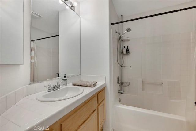 bathroom with vanity and bathtub / shower combination