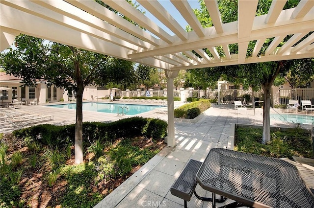 view of swimming pool featuring a patio area and a pergola