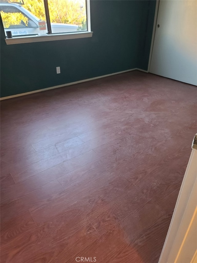 empty room with hardwood / wood-style flooring