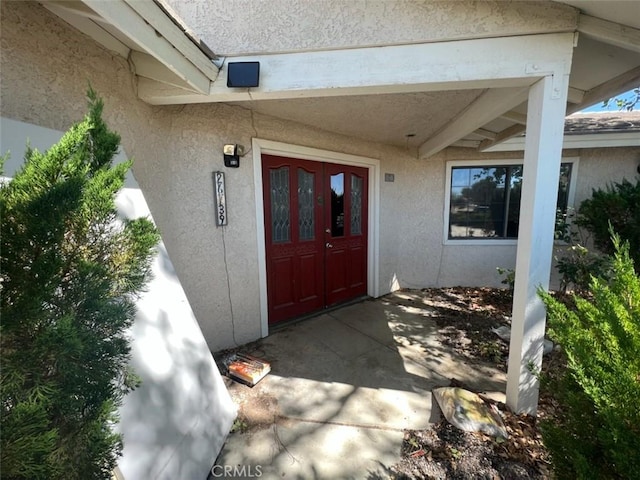 property entrance featuring french doors