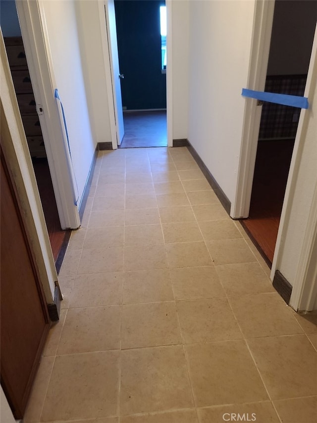 hall featuring light tile patterned floors