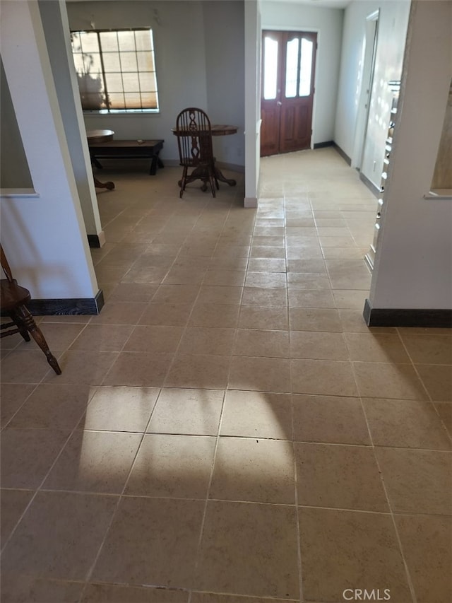 hallway featuring tile patterned flooring