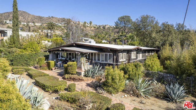 rear view of house featuring a mountain view