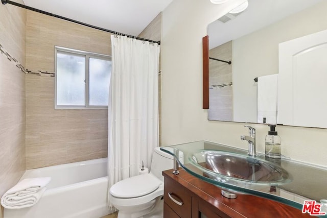 full bathroom featuring vanity, shower / bath combination with curtain, and toilet