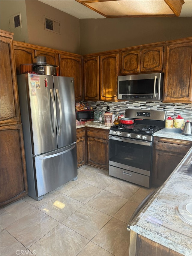 kitchen featuring tasteful backsplash and stainless steel appliances