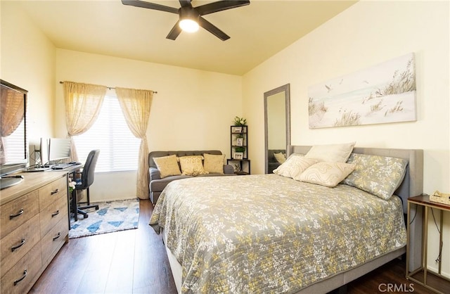 bedroom with dark hardwood / wood-style floors and ceiling fan