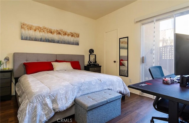 bedroom with dark hardwood / wood-style flooring