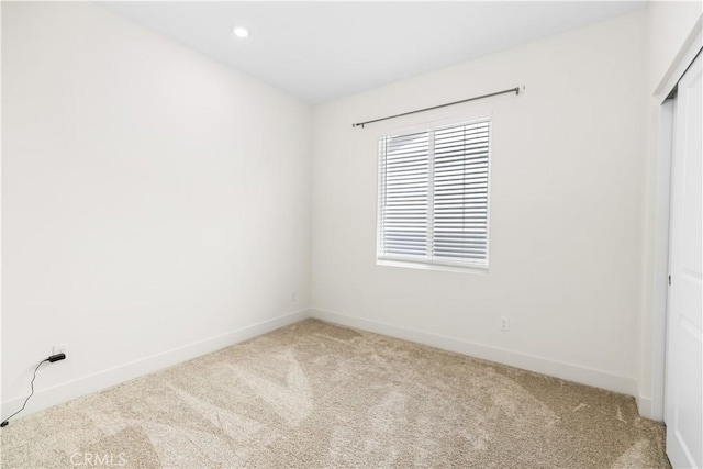 interior space featuring a closet and light carpet