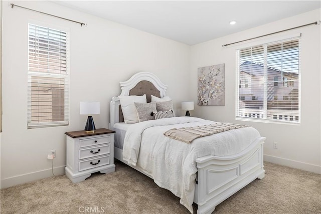 carpeted bedroom featuring multiple windows