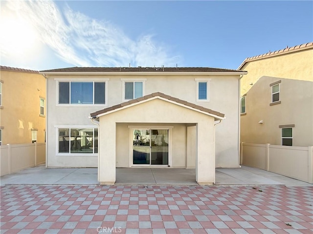 rear view of property featuring a patio