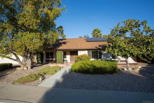 ranch-style house with solar panels