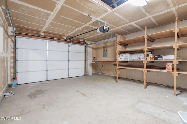 garage with a garage door opener and electric panel