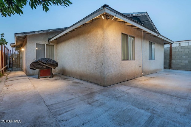 view of side of property with a patio area