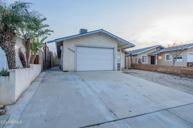 ranch-style home featuring a garage and central AC unit