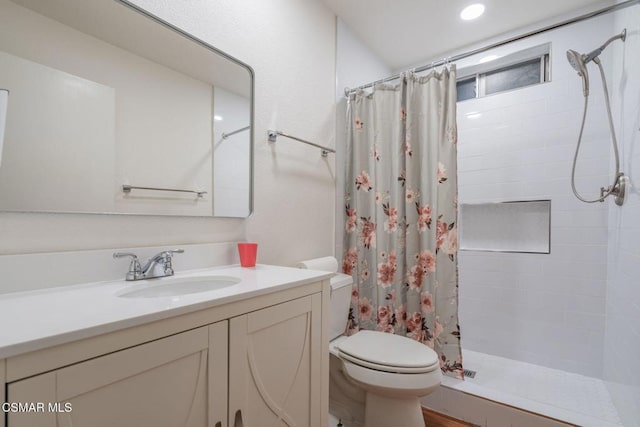 bathroom with vanity, curtained shower, and toilet