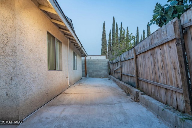 view of side of property featuring a patio area