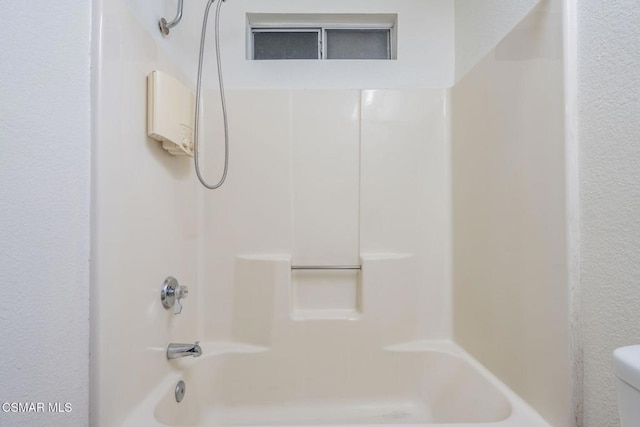 bathroom with toilet and shower / bath combination