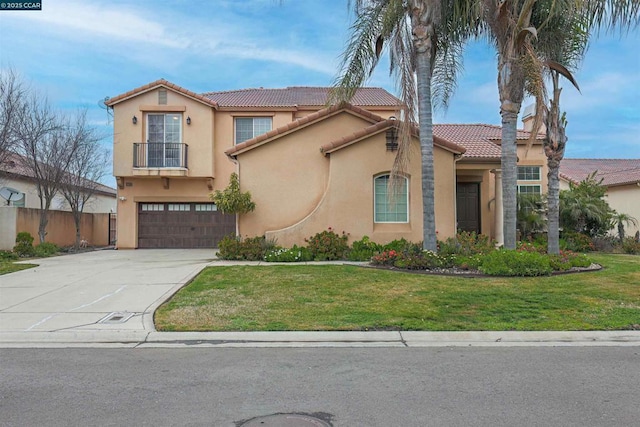 mediterranean / spanish-style house with a garage and a front yard