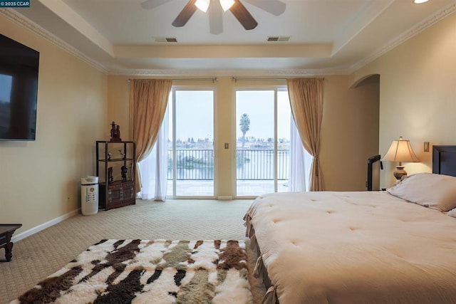 carpeted bedroom with crown molding, access to outside, and a raised ceiling