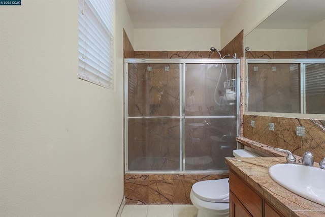 full bathroom with enclosed tub / shower combo, vanity, tile patterned flooring, and toilet