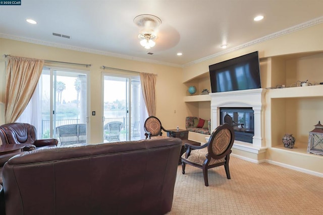 carpeted living room with ornamental molding and built in features