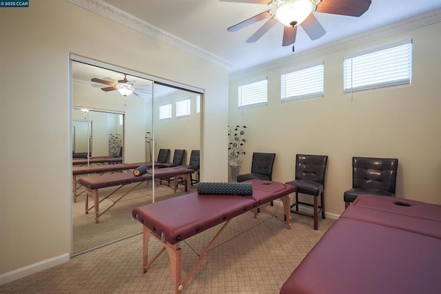 interior space with crown molding, ceiling fan, and light carpet