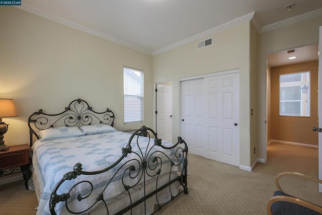 bedroom with a closet, ornamental molding, and light carpet