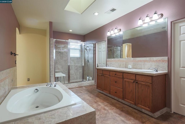 bathroom featuring vanity, a skylight, plus walk in shower, and tasteful backsplash