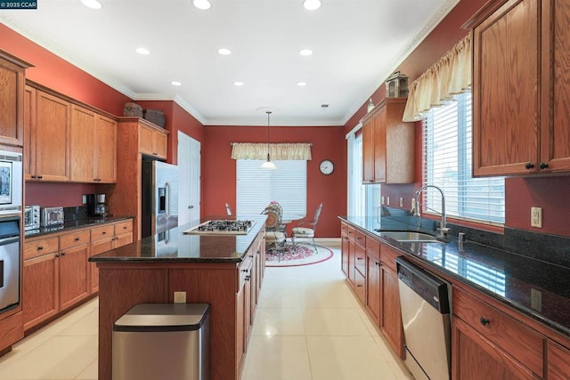 kitchen featuring sink, a center island, dark stone counters, pendant lighting, and stainless steel appliances