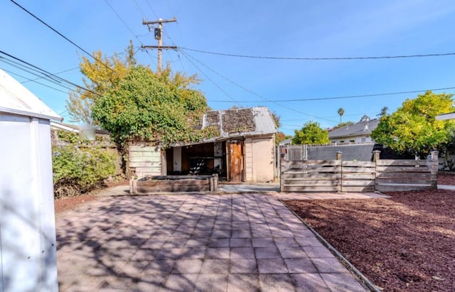 view of patio with an outbuilding