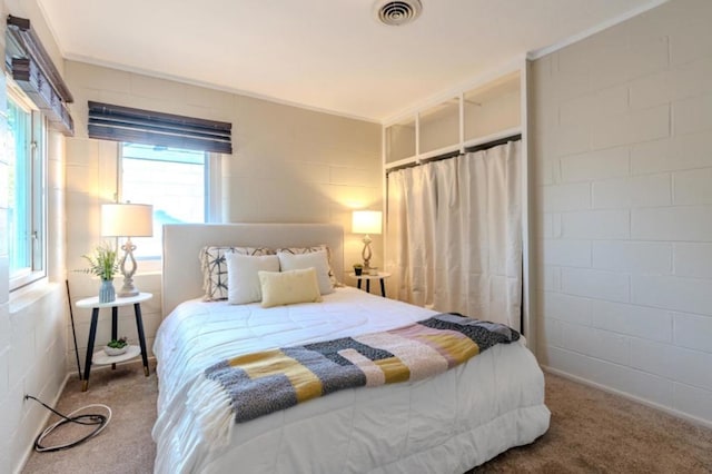 carpeted bedroom featuring crown molding