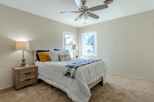 carpeted bedroom with brick wall and ceiling fan