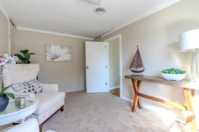 living area featuring light carpet and ornamental molding