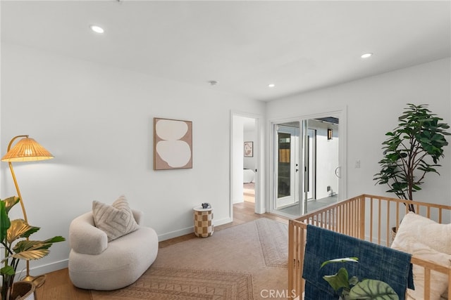 bedroom featuring light hardwood / wood-style floors and a nursery area