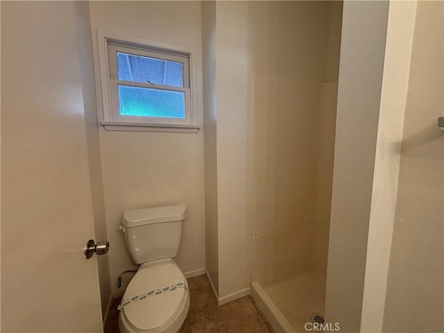 bathroom featuring walk in shower and toilet