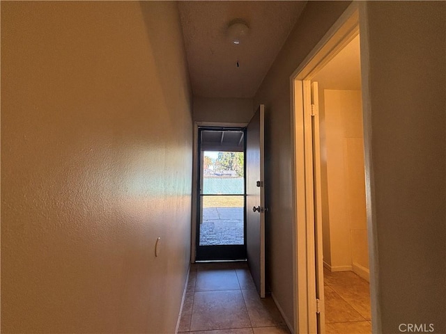 doorway with light tile patterned floors