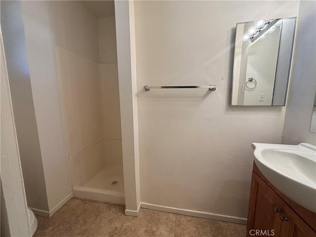 bathroom with vanity and a shower