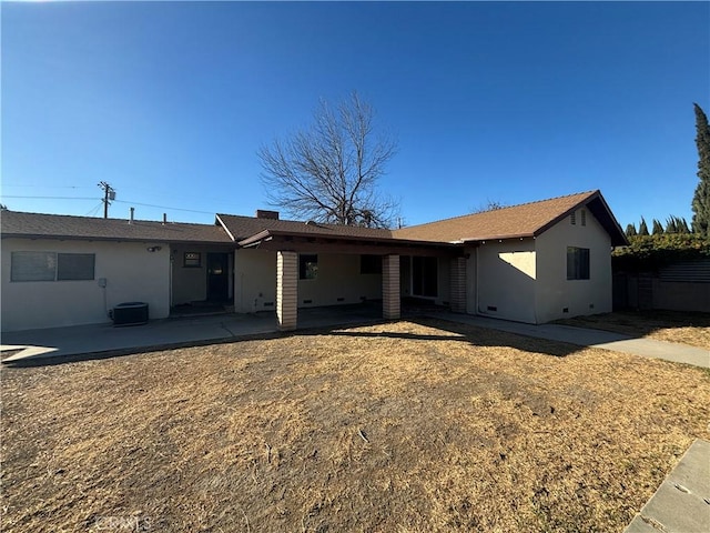 rear view of house with a patio and cooling unit