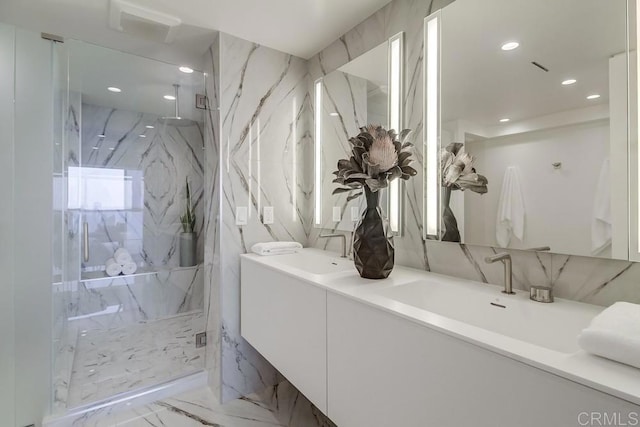 bathroom featuring vanity and a shower with shower door