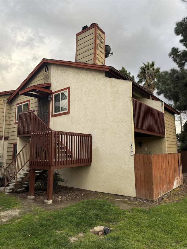 rear view of property with a lawn